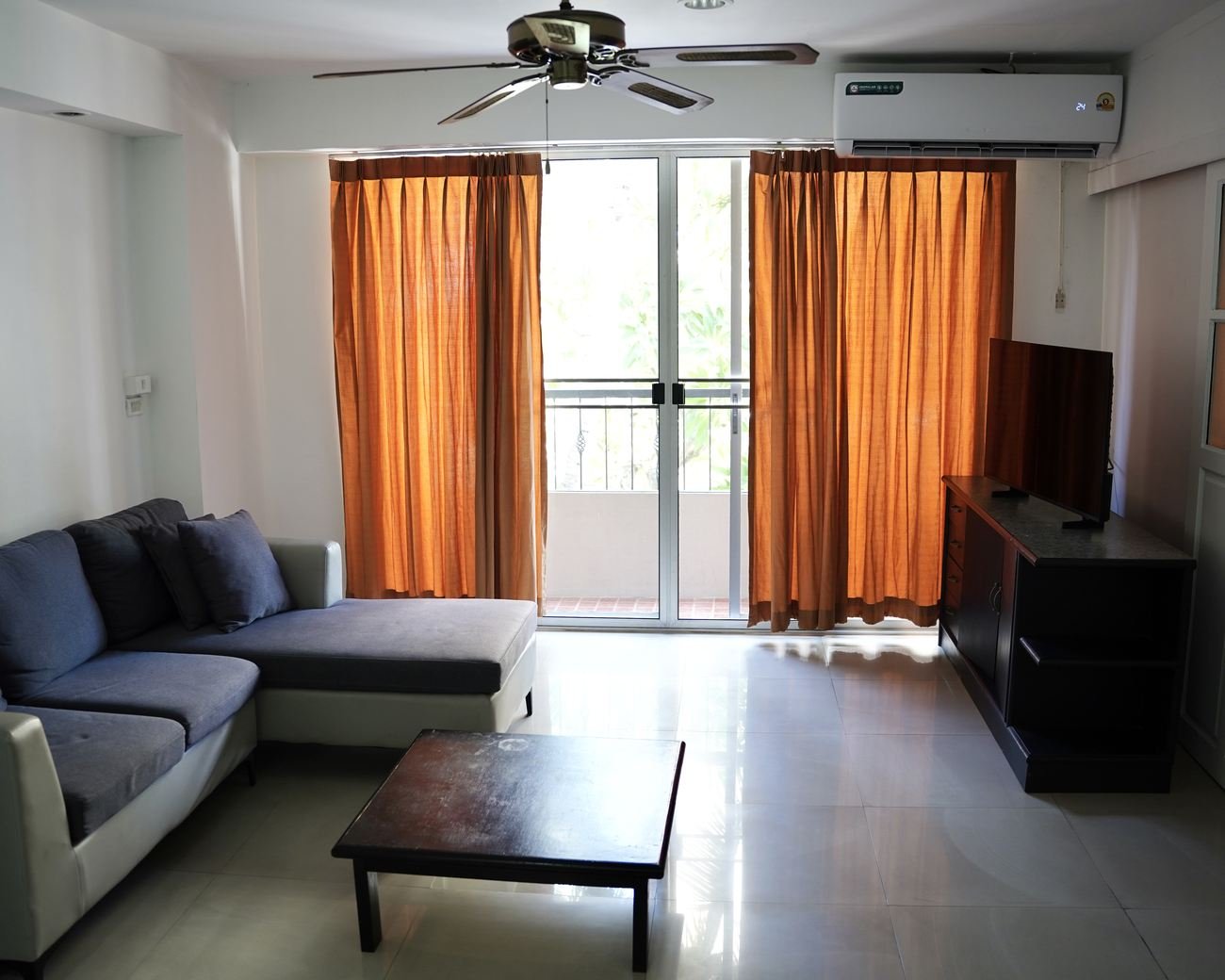 Suite living room with corner sofa and balcony doors