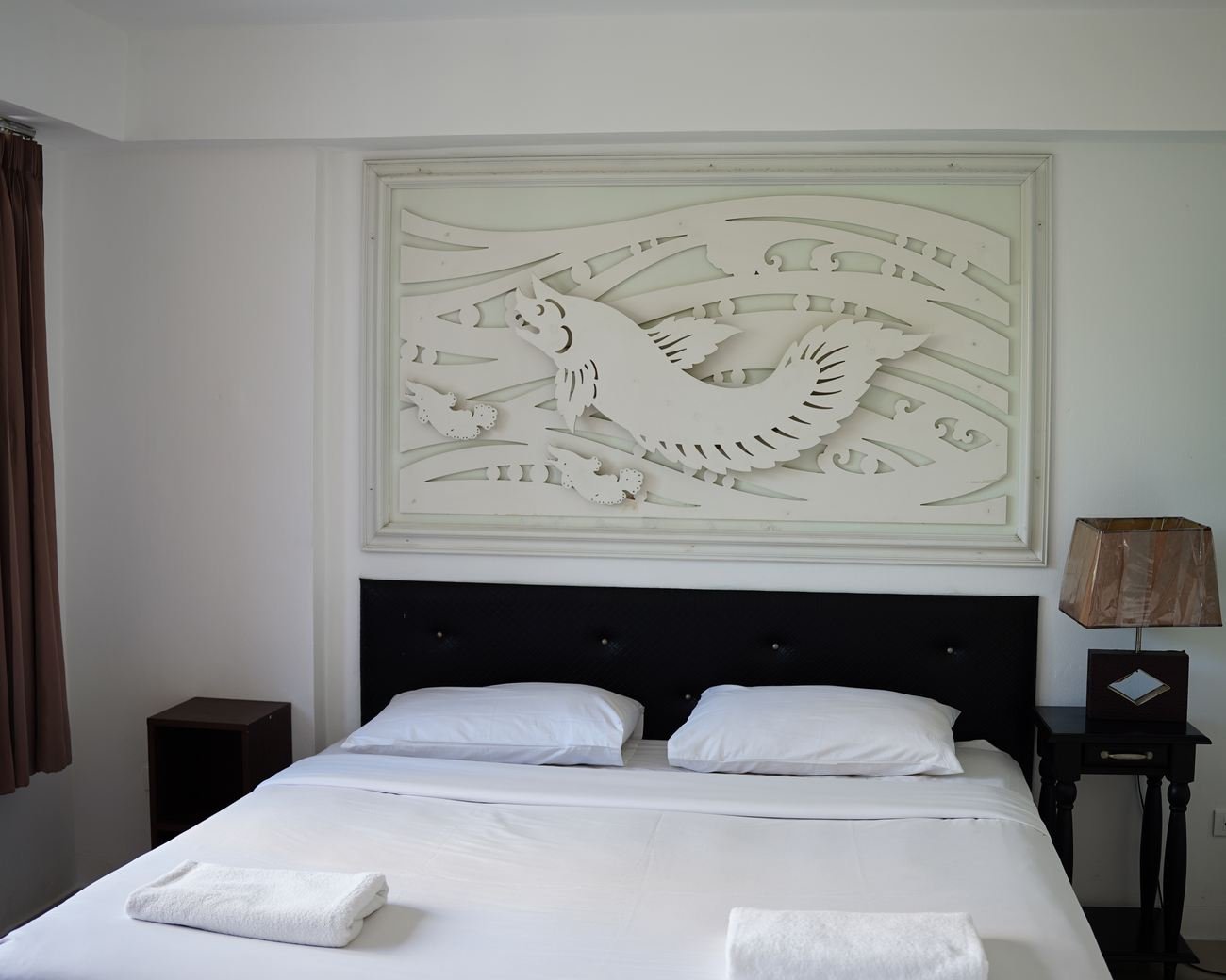 Suite bedroom with carved wall panel above the bed